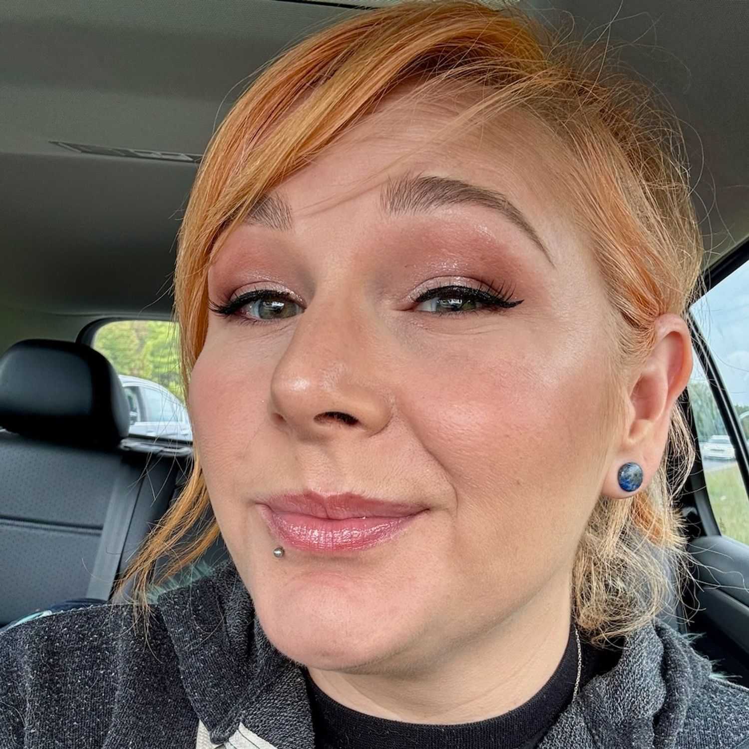 Portrait of Lila Kinney, a professional stylist at Q Salon & Spa, showcasing their expertise and style.