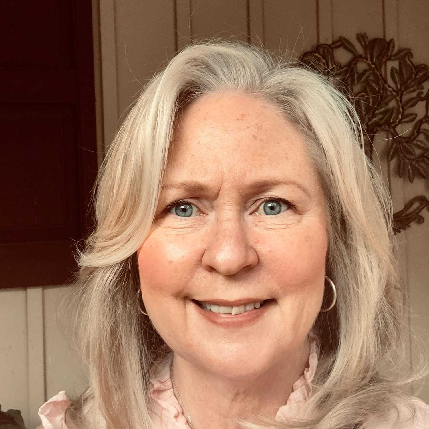 Portrait of Susan Ingman, a professional stylist at Q Salon & Spa, showcasing their expertise and style.