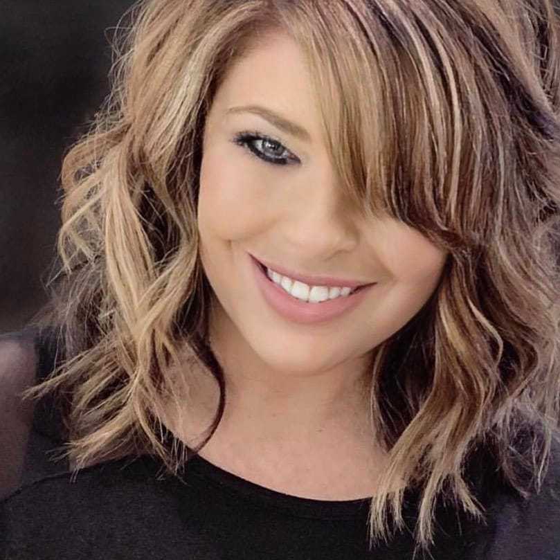 Portrait of Maria Ball, a professional stylist at Q Salon & Spa, showcasing their expertise and style.