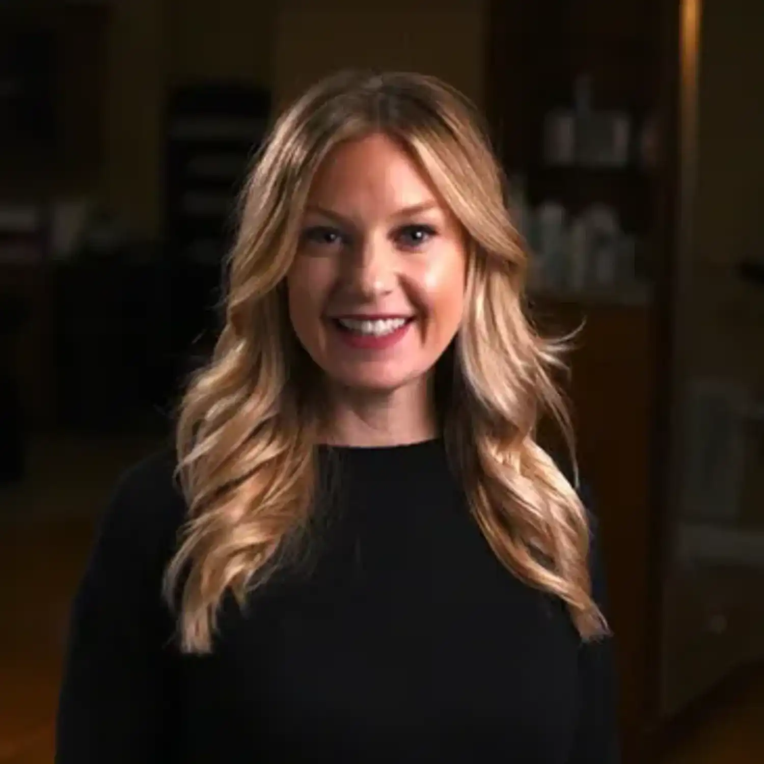 Portrait of Jennifer Holzer, a professional stylist at Q Salon & Spa, showcasing their expertise and style.