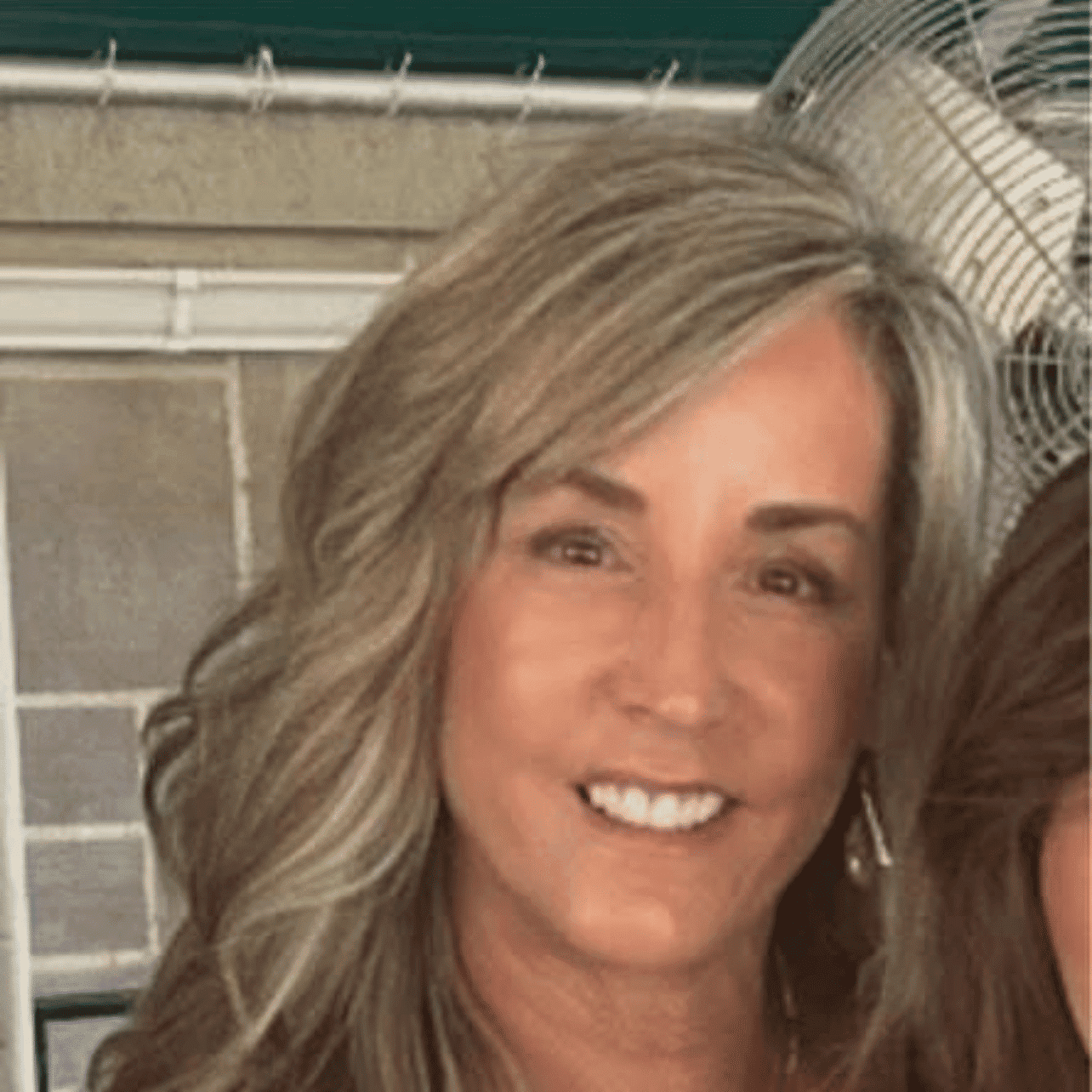 Portrait of Colleen Kemp, a professional stylist at Q Salon & Spa, showcasing their expertise and style.