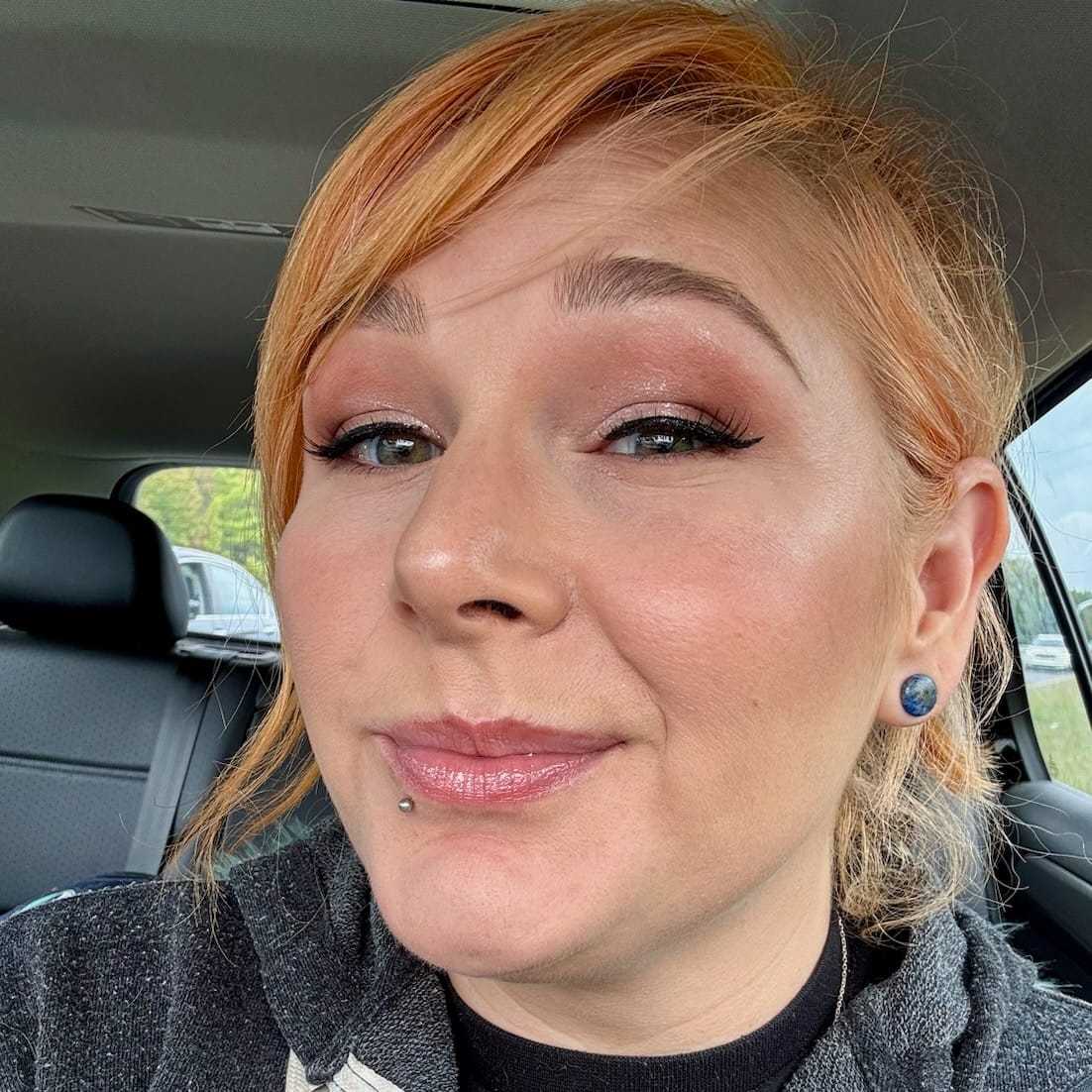 Portrait of Lila Kinney, a professional stylist at Q Salon & Spa, showcasing their expertise and style.