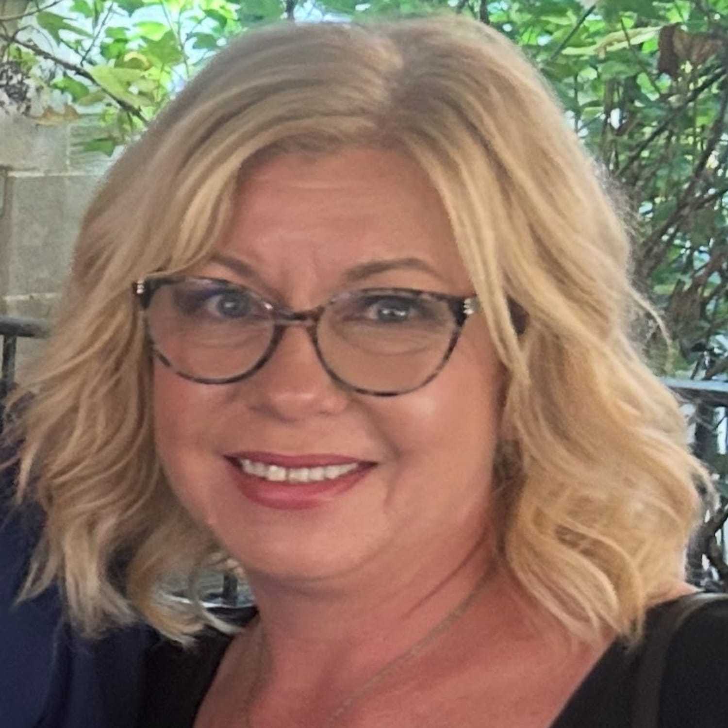 Portrait of Christine Boub, a professional stylist at Q Salon & Spa, showcasing their expertise and style.