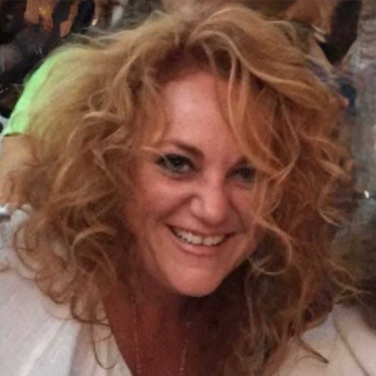 Portrait of Kimberly Pini, a professional stylist at Q Salon & Spa, showcasing their expertise and style.