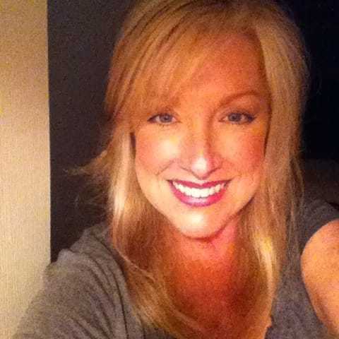 Portrait of Heather Brong, a professional stylist at Q Salon & Spa, showcasing their expertise and style.