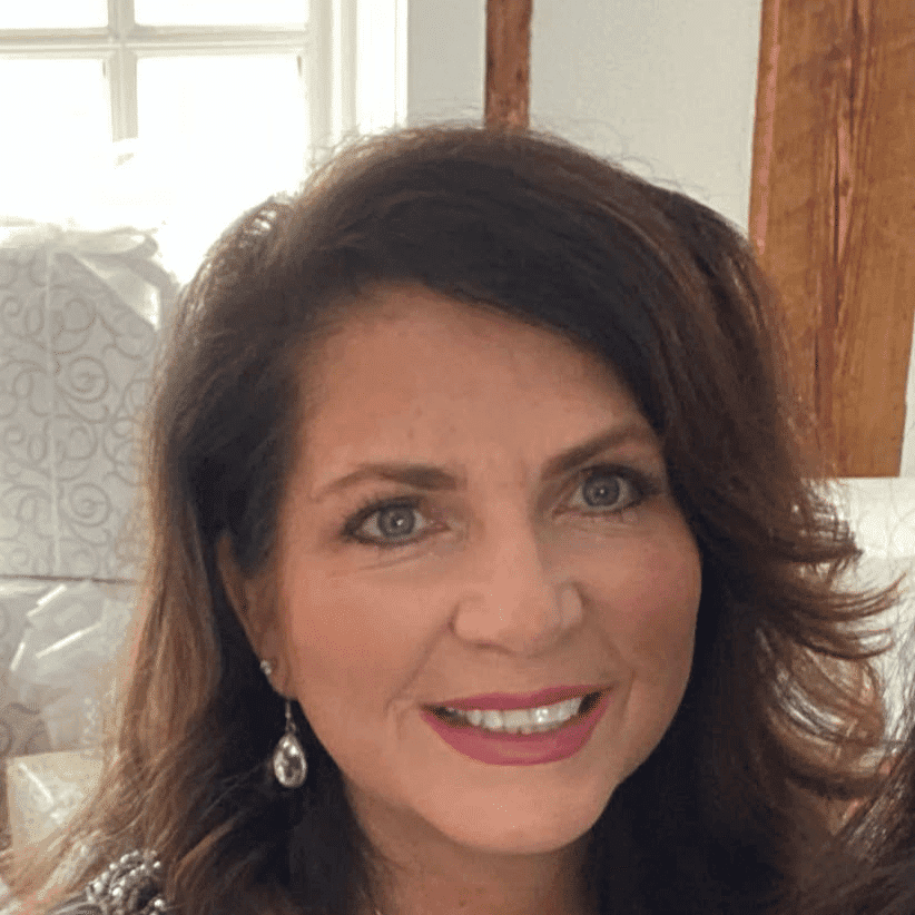 Portrait of Denise Cesarine, a professional stylist at Q Salon & Spa, showcasing their expertise and style.