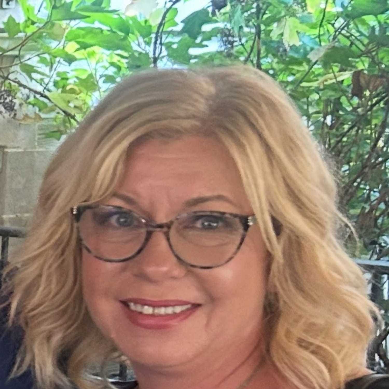 Portrait of Christine Boub, a professional stylist at Q Salon & Spa, showcasing their expertise and style.