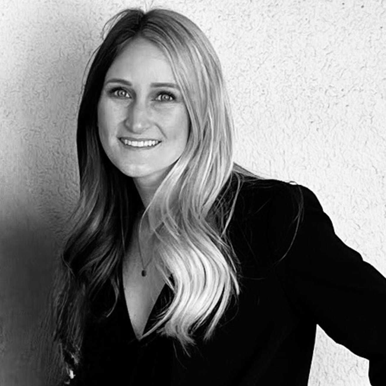 Portrait of Logan Fear, a professional stylist at Q Salon & Spa, showcasing their expertise and style.