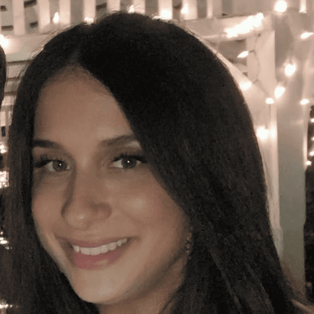 Portrait of Angela Seramone, a professional stylist at Q Salon & Spa, showcasing their expertise and style.