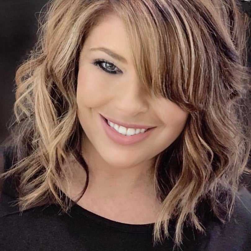 Portrait of Maria Ball, a professional stylist at Q Salon & Spa, showcasing their expertise and style.