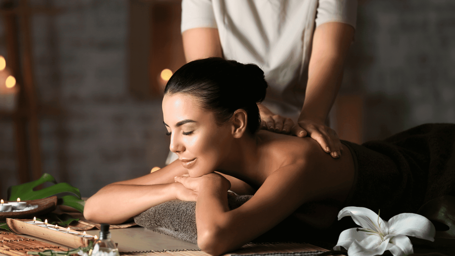 Woman enjoying a relaxing back massage in a serene spa setting.
