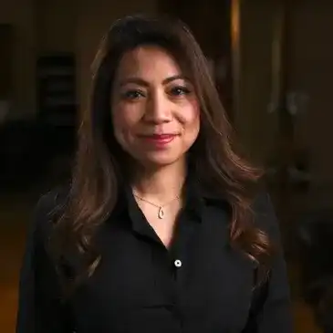 Portrait of Kim Trac, a professional stylist at Q Salon & Spa, showcasing their expertise and style.