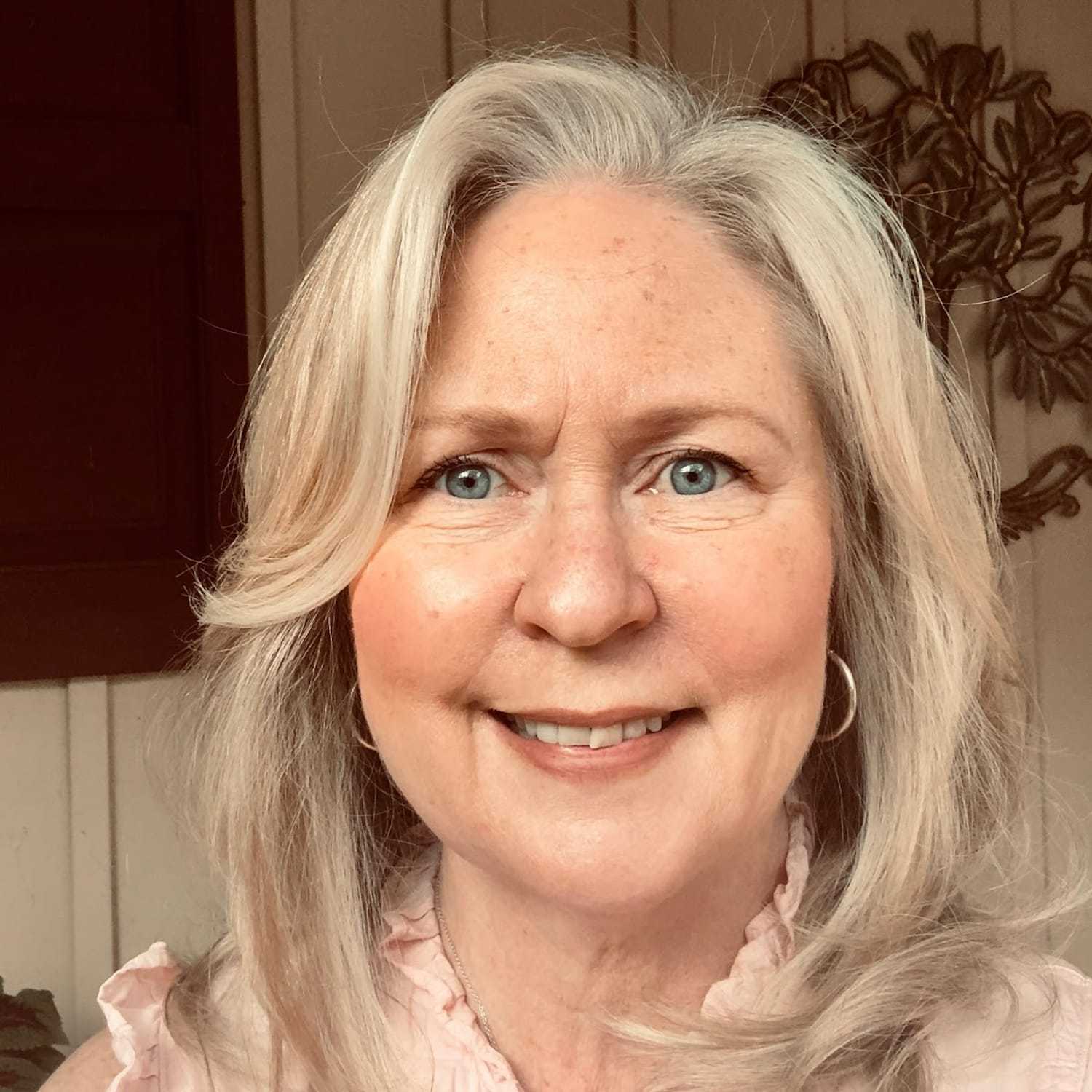 Portrait of Susan Ingman, a professional stylist at Q Salon & Spa, showcasing their expertise and style.