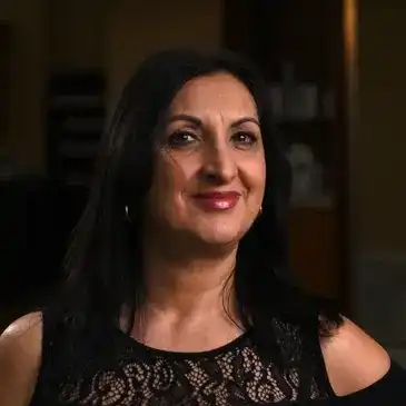 Portrait of Voula Karalis, a professional stylist at Q Salon & Spa, showcasing their expertise and style.