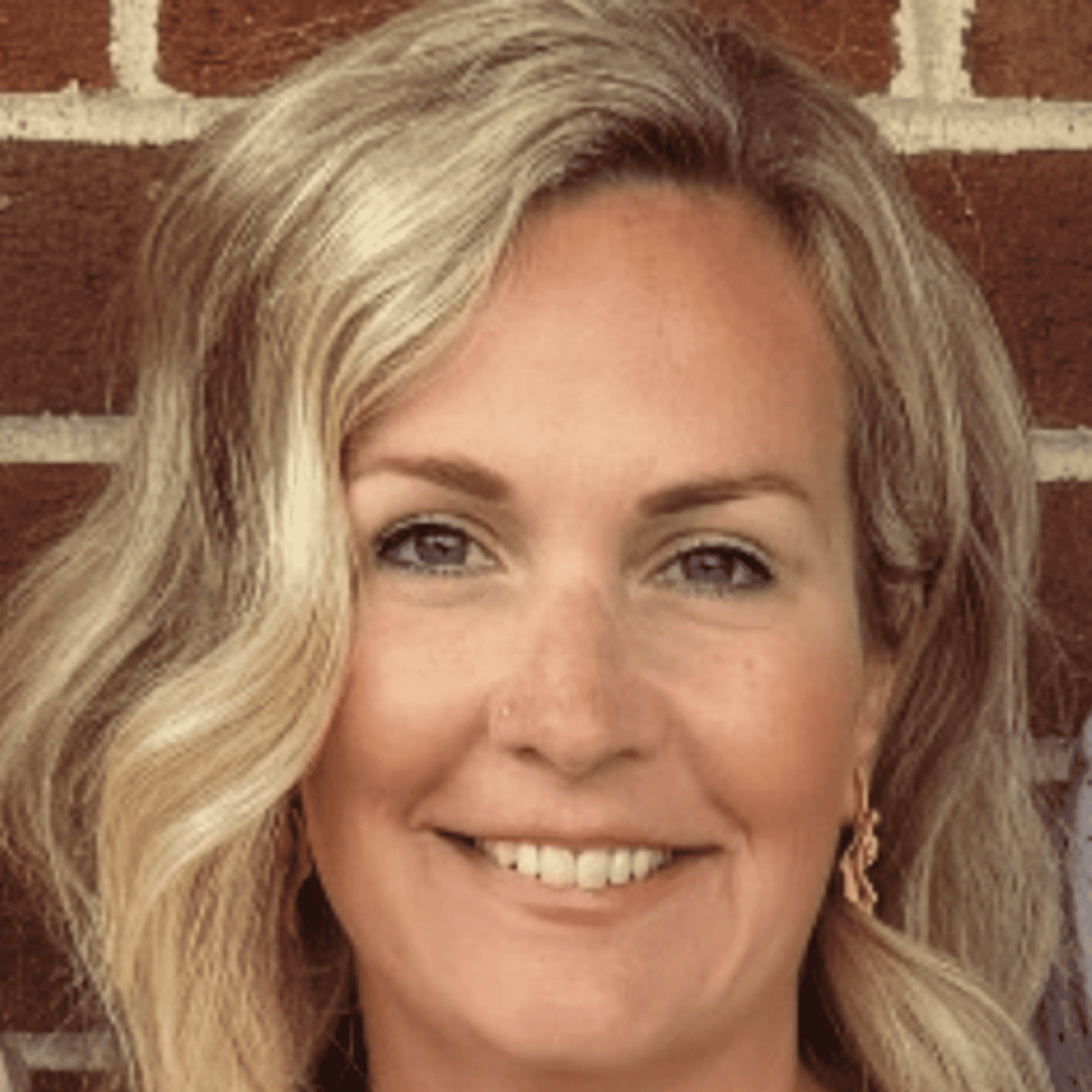 Portrait of Jaime Lyn Strano, a professional stylist at Q Salon & Spa, showcasing their expertise and style.