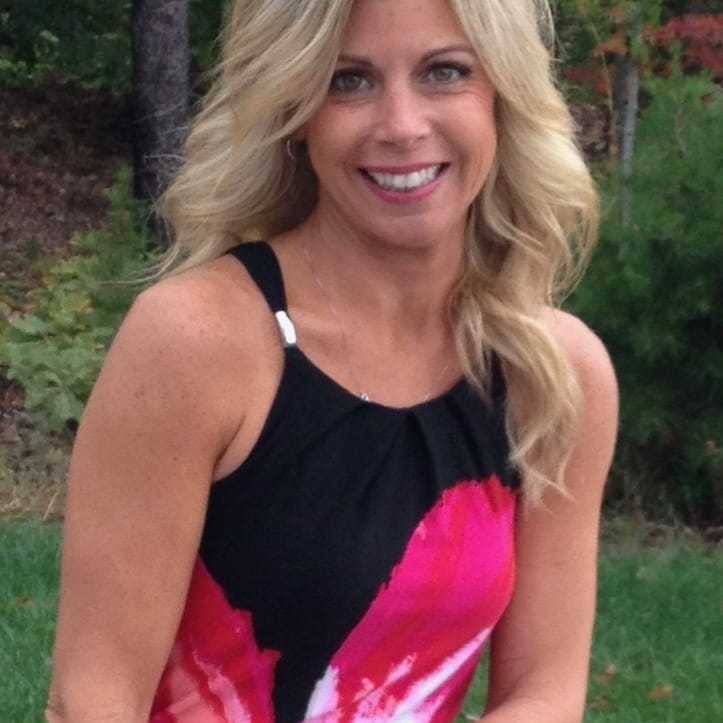 Portrait of Lori Lewis, a professional stylist at Q Salon & Spa, showcasing their expertise and style.