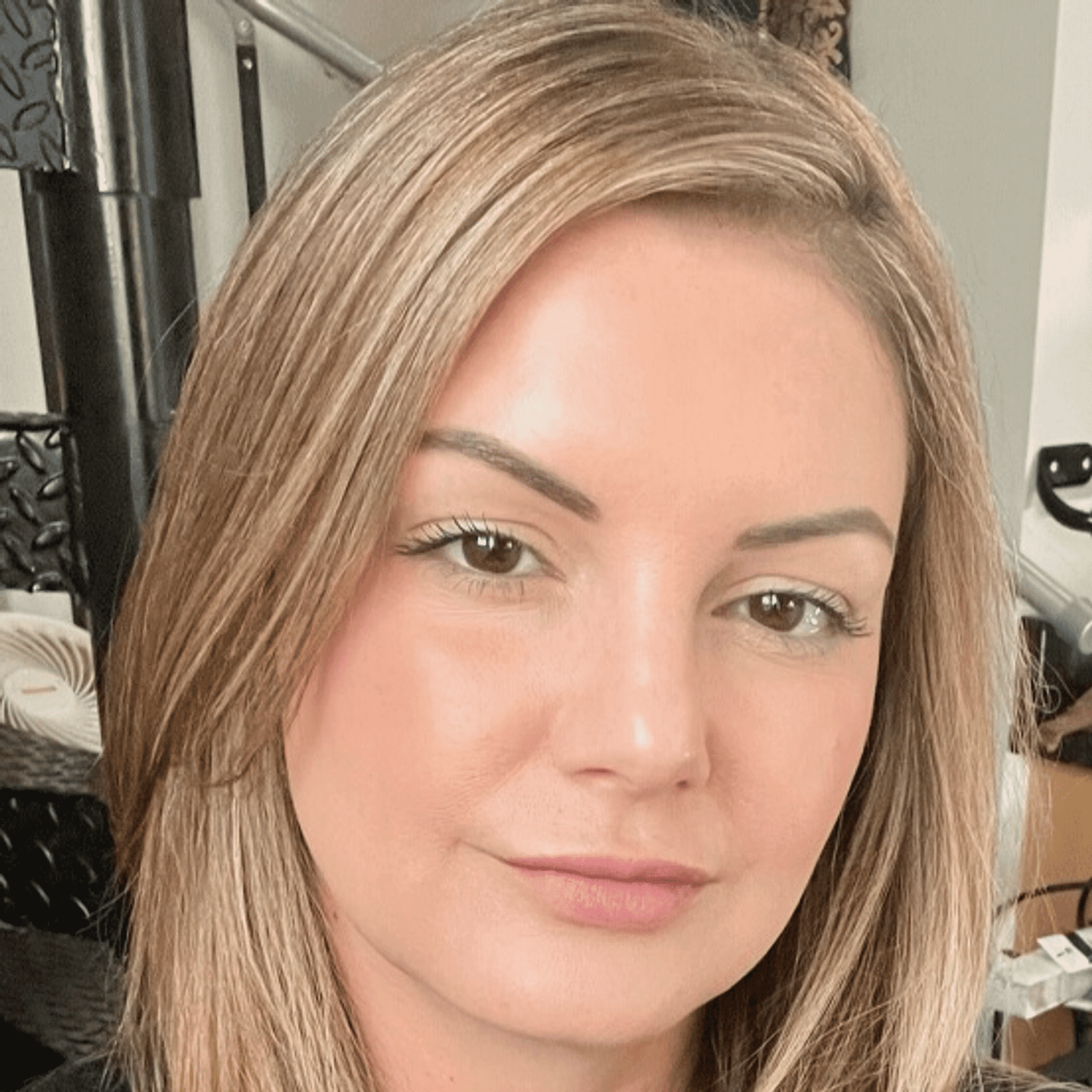 Portrait of Steph Nicole, a professional stylist at Q Salon & Spa, showcasing their expertise and style.