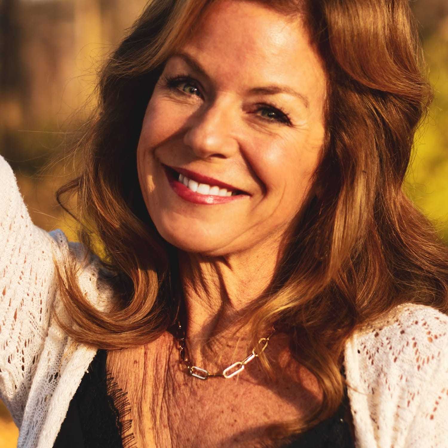 Portrait of Barb Leone, a professional stylist at Q Salon & Spa, showcasing their expertise and style.