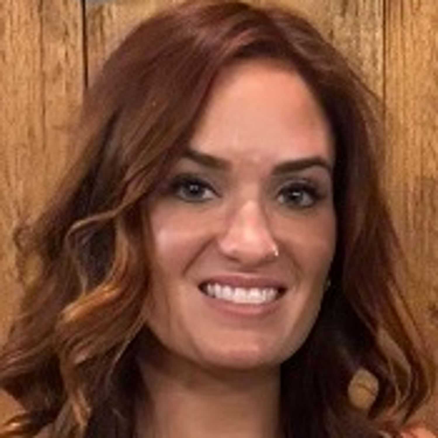 Portrait of Nina Nociti Acton, a professional stylist at Q Salon & Spa, showcasing their expertise and style.