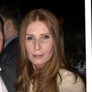 Portrait of Colleen Gallagher, a professional stylist at Q Salon & Spa, showcasing their expertise and style.